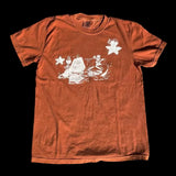 Orange t-shirt with a graphic design on a textured surface