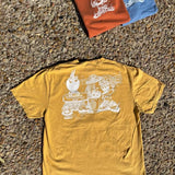 Yellow t-shirt with a graphic design on a textured surface