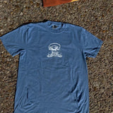 Blue t-shirt with a white graphic on a textured surface