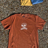Brown t-shirt with a white graphic on a textured surface