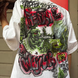 White t-shirt with colorful graphic designs on the back, worn by a person.