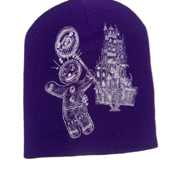 Embroidered beanie with a gingerbread man and castle design on a purple background