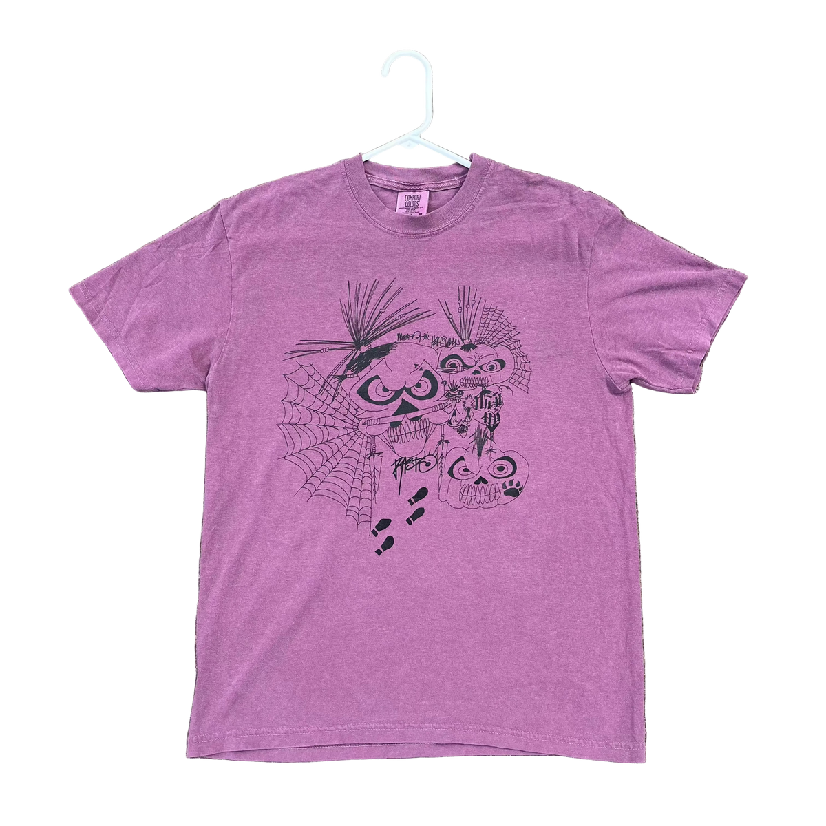 Purple t-shirt with a graphic design on a textured surface