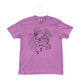 Purple t-shirt with a graphic design on a textured surface