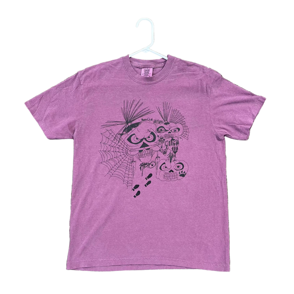 Purple t-shirt with a graphic design on a textured surface