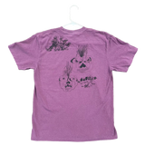Purple t-shirt with black graphics on a textured surface